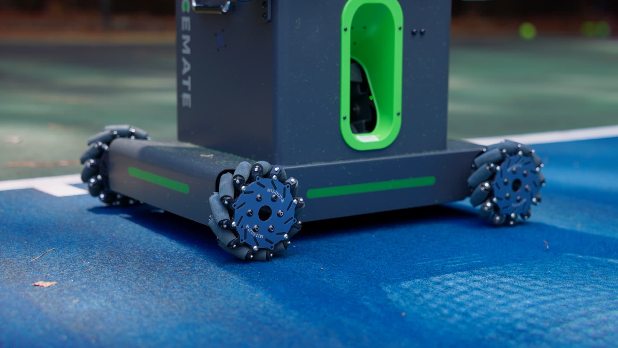 Close-up of the AceMate tennis robot on the court