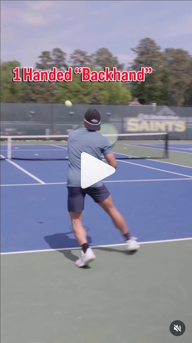 Still from the one handed backhand reel, mid-swing at the baseline